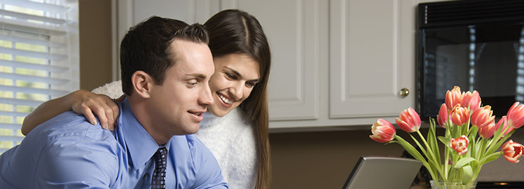 happy couple with laptop